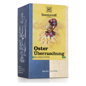 Verpackung von Sonnentor Bio Kräutertee 'Oster Überraschung' mit bunter Illustration eines Hasen und Küken.